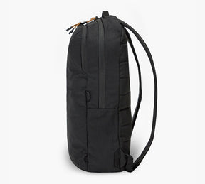 Side view of black packable backpack with two zippered compartments and slim shoulder straps.