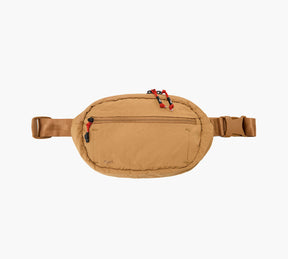 Tan packable sling bag with front zip pocket, red cord zipper pulls, adjustable strap