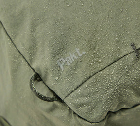 Close-up of water-resistant fabric with water droplets and the word 'PakL' visible