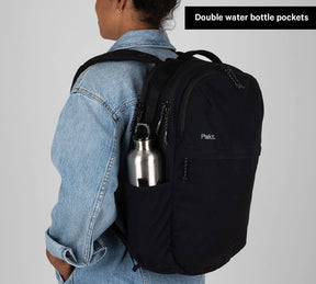 Black Everyday 22L backpack worn by person, stainless water bottle in side pocket — Double water bottle pockets.