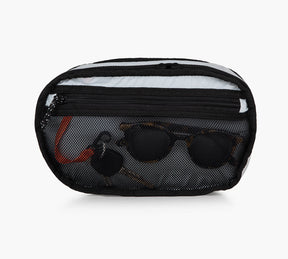 Black Everyday 3L Sling bag with front mesh pocket containing sunglasses and a keychain.