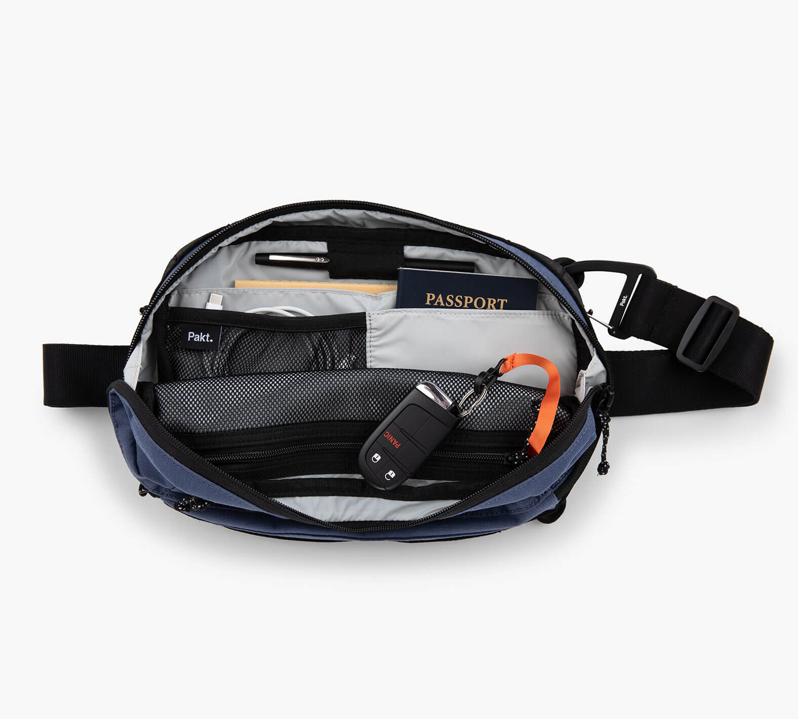 Open Everyday 5L Sling bag showing organized interior with passport, wallet, keys, and other items.