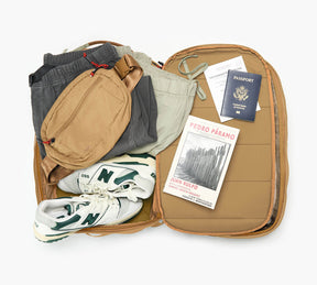 An overhead shot showing the interior of the Aero Travel Backpack in Mojave.