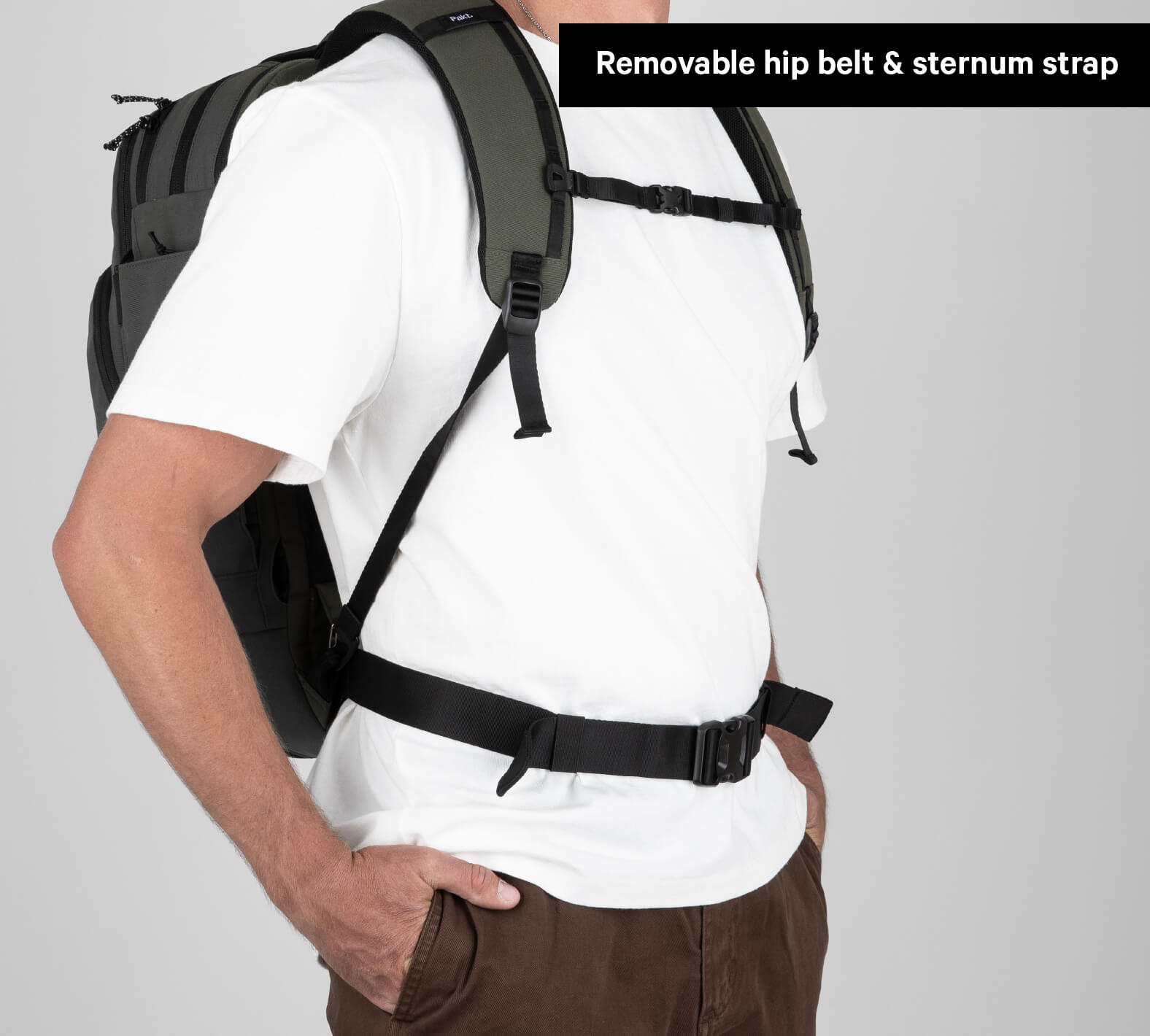 Backpack worn by a person with removable hip belt and sternum strap label.