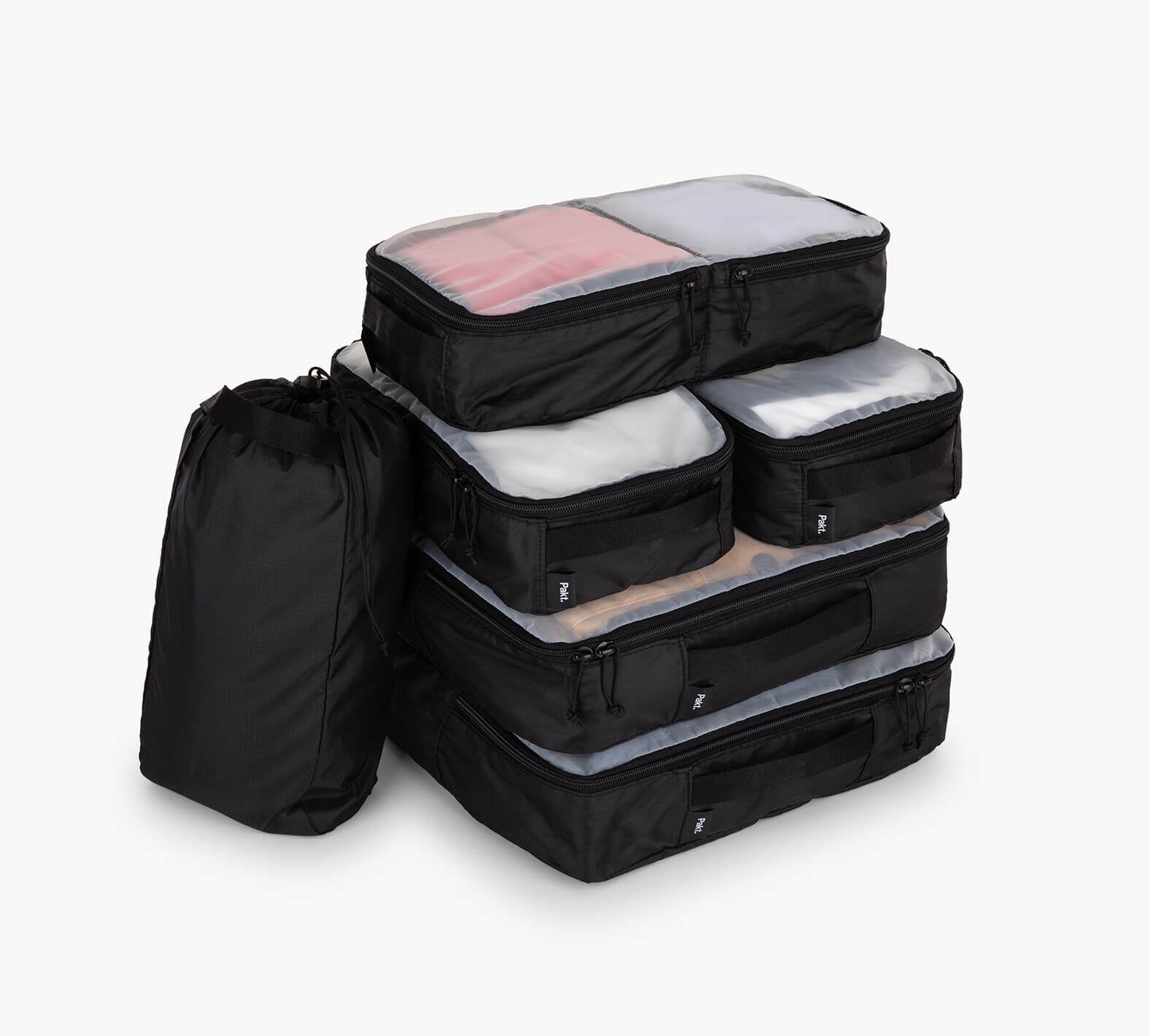 Stack of five black packing cubes with translucent mesh tops and one black drawstring pouch