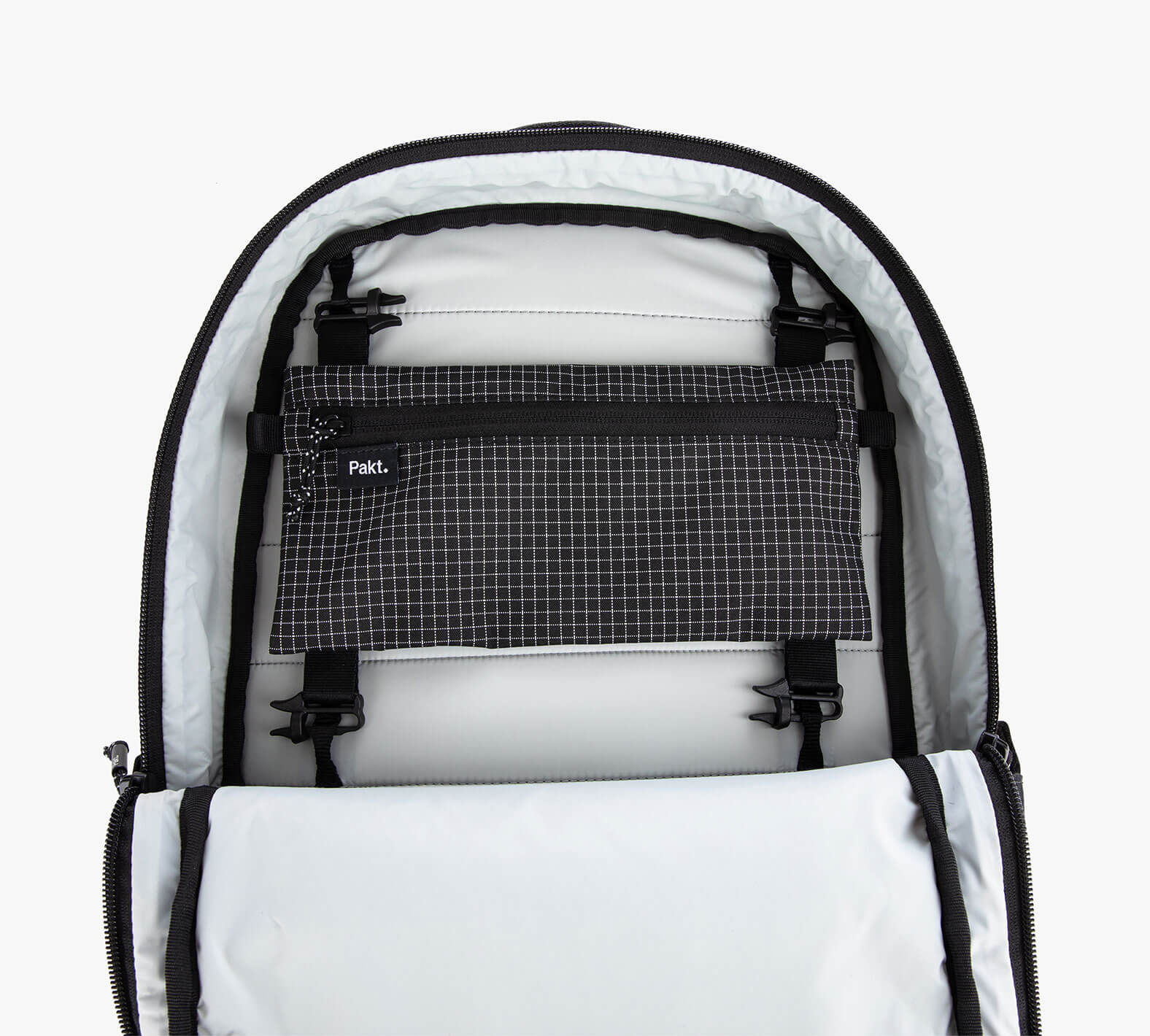 Black and white checkered Clip-In Pouch with clips inside a white sling bag