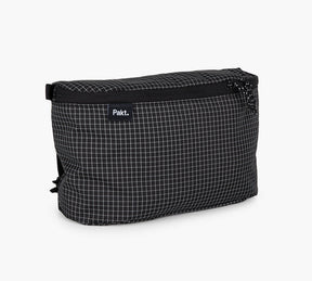 Black grid-patterned storage pouch with a visible 'Pakt.' label