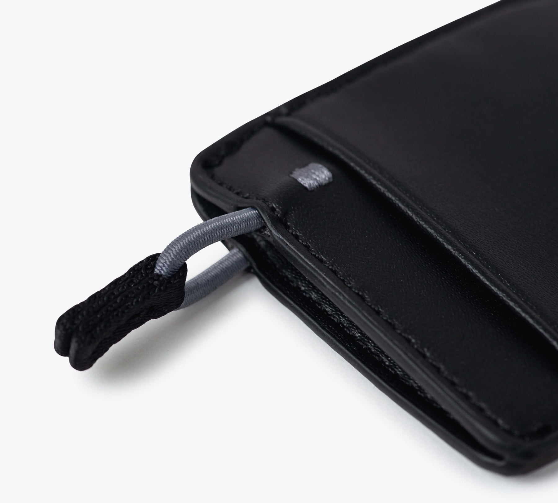 Close-up of a black Mojito Wallet corner showing a fabric loop attached to a metal ring