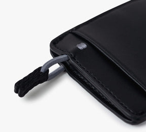 Close-up of a black Mojito Wallet corner showing a fabric loop attached to a metal ring